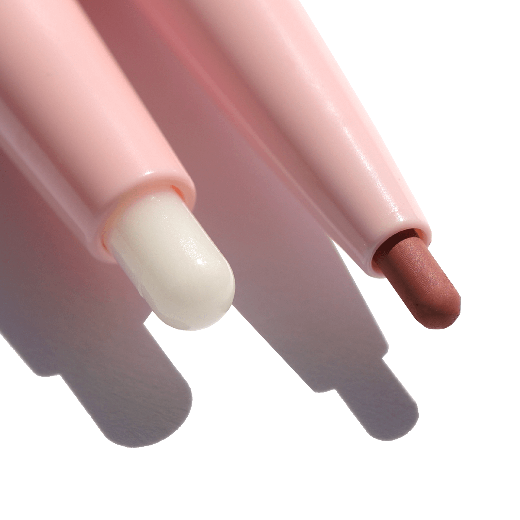 Close-up of The Script Primer + Lip Liner, showcasing two pink retractable lip liner pencils designed for precise, long-lasting lip definition and smudge-proof wear.