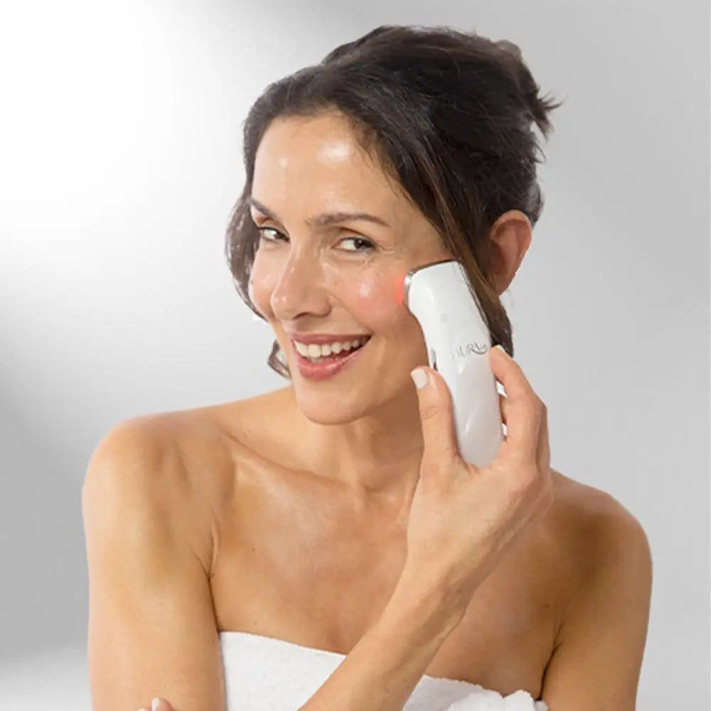 Woman using Aura Lift Skin-Tightening Device on her face