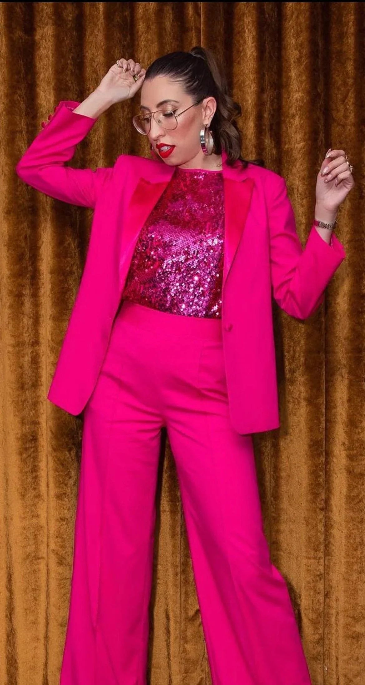 Woman in a bright pink suit wearing stylish 2.5 Skylar Hoops earrings