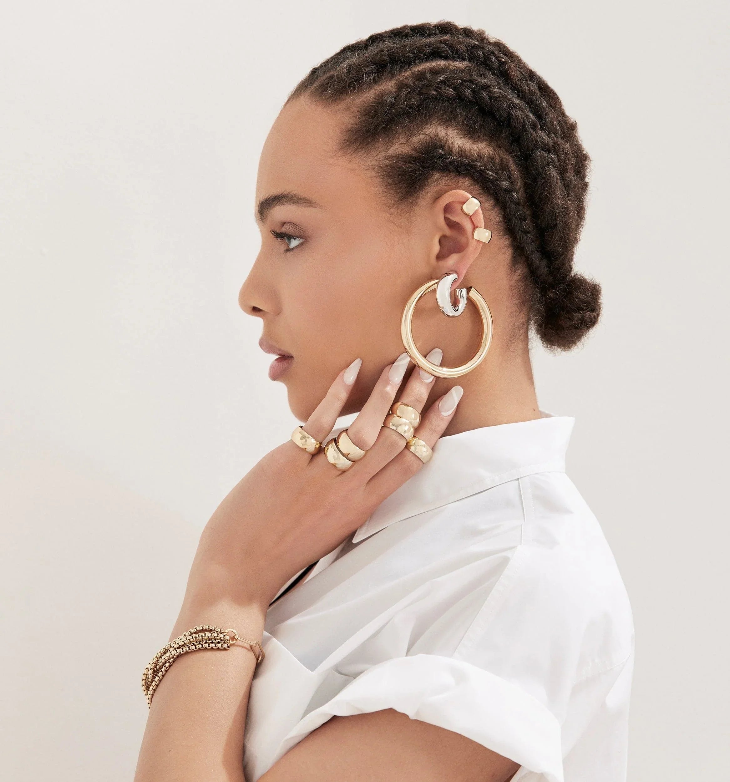 Woman wearing stylish gold Baby Ryan Hoops earrings for a chic look