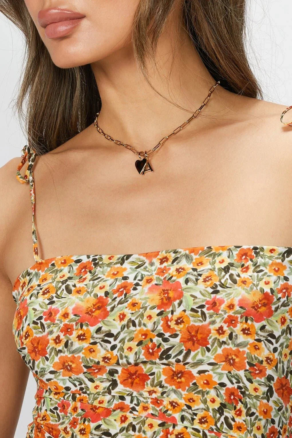 Floral print dress with spaghetti straps paired with the Cara Charm Necklace