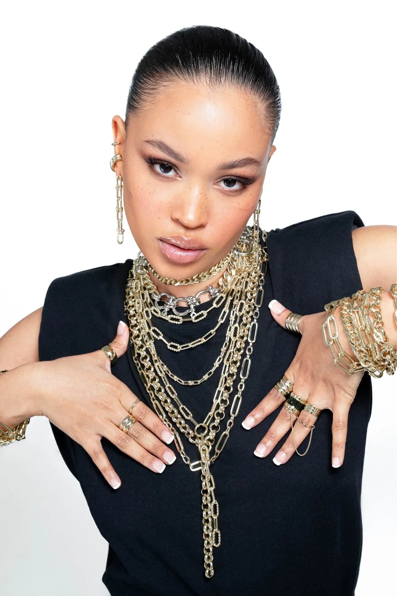 Woman wearing beautiful gold jewelry featuring the Enzo Necklace