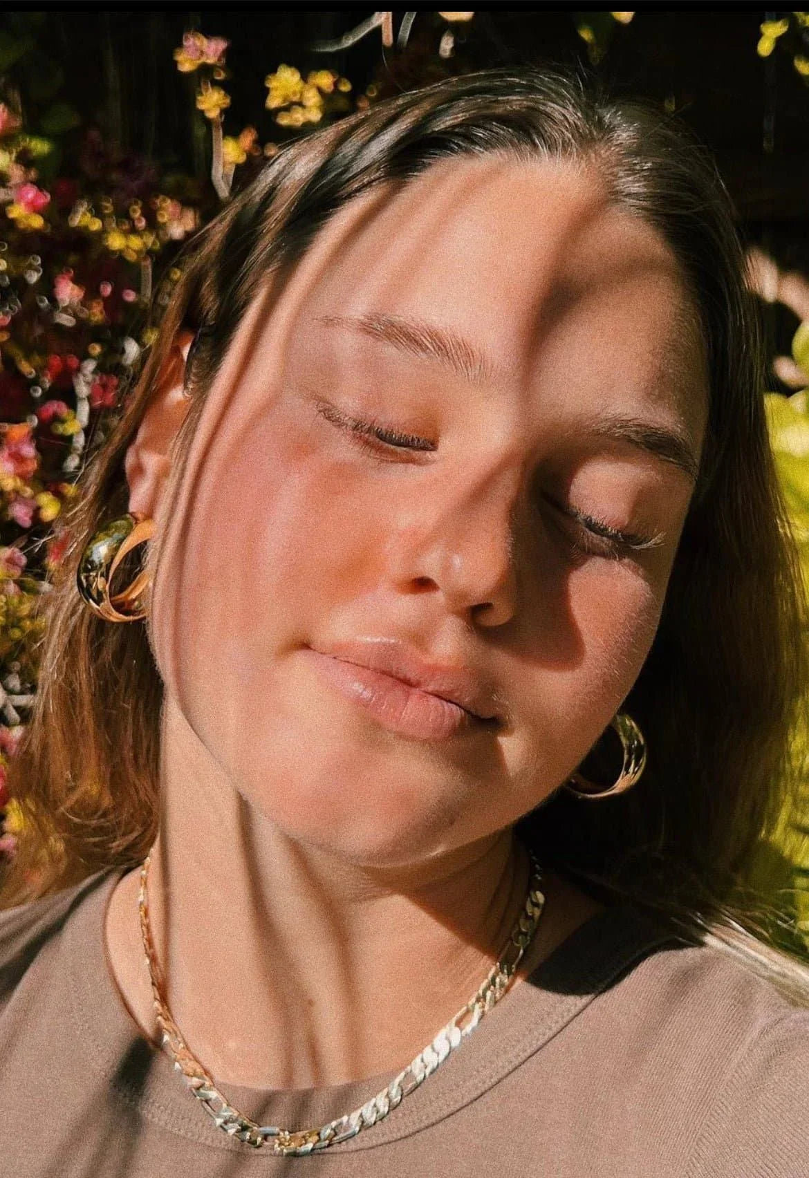 Woman wearing Simone Hoops gold jewelry looking stylish and chic