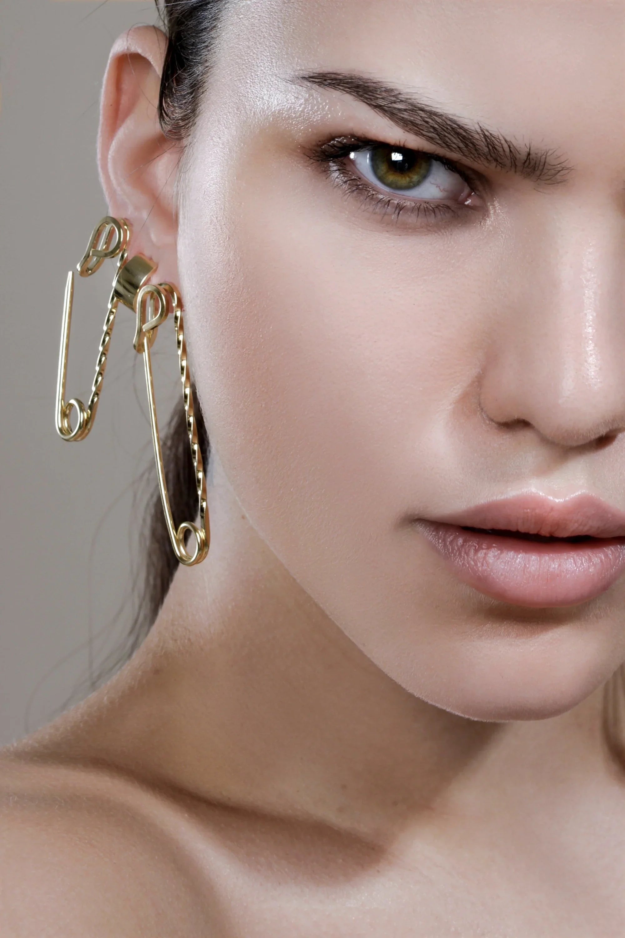 Gold safety pin earrings showcased in the Small Twisted Safety Pin Earrings product images