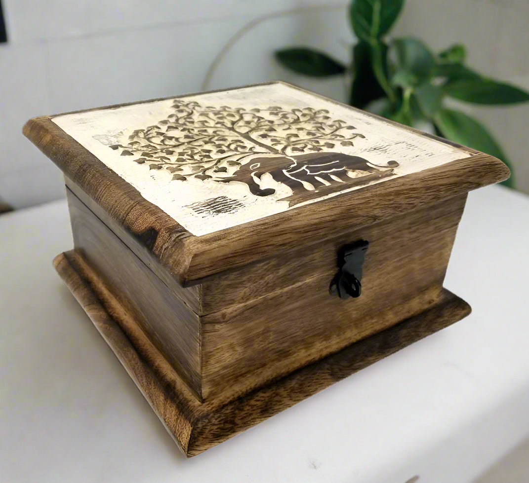 Hand carved wooden box with an inlay of a brass elephant god Ganesha on the lid, featuring a handle and a perforated design.
