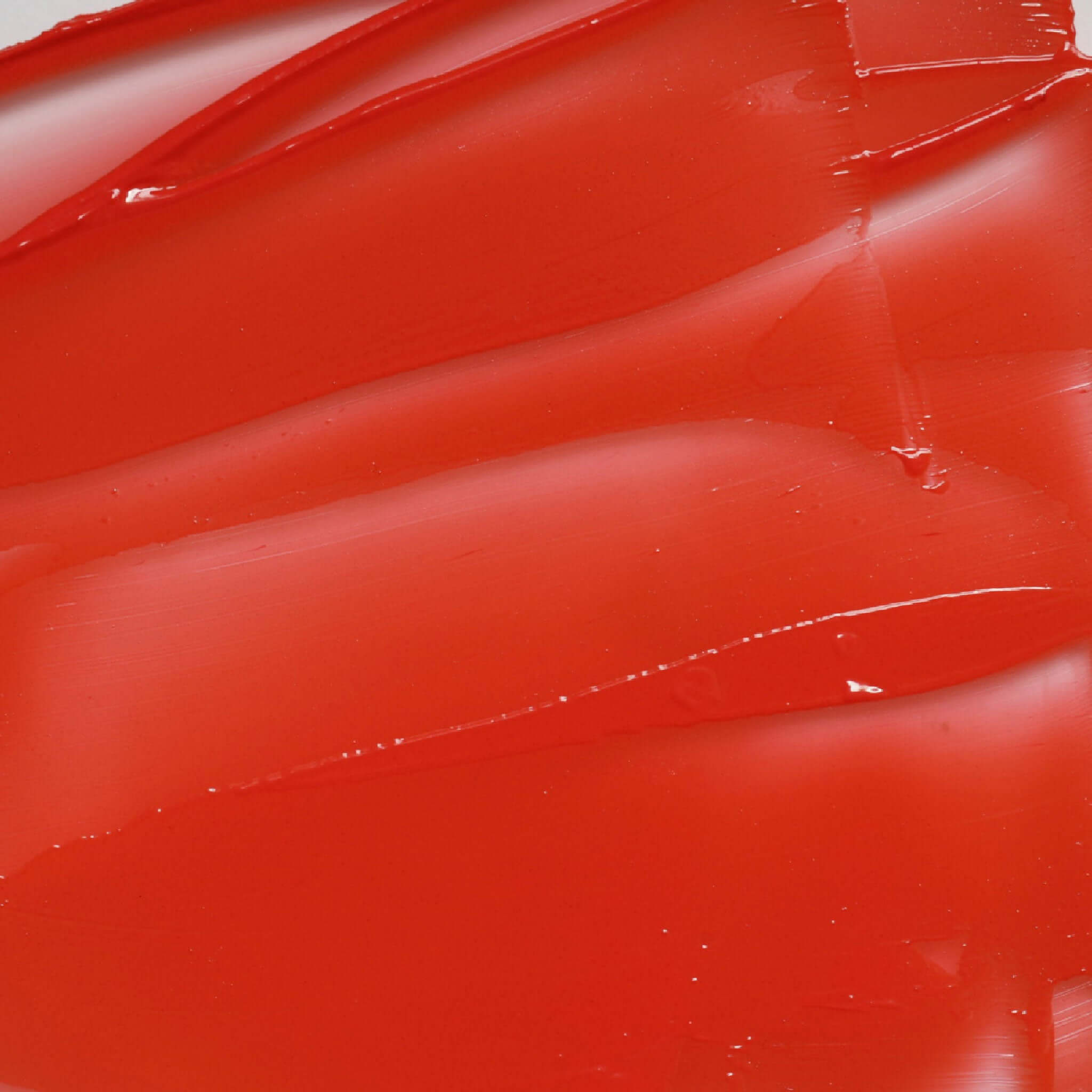 Close-up of Candy Paint Cheek + Lip Tint showing the creamy texture and vibrant color for a buildable and blendable glow.