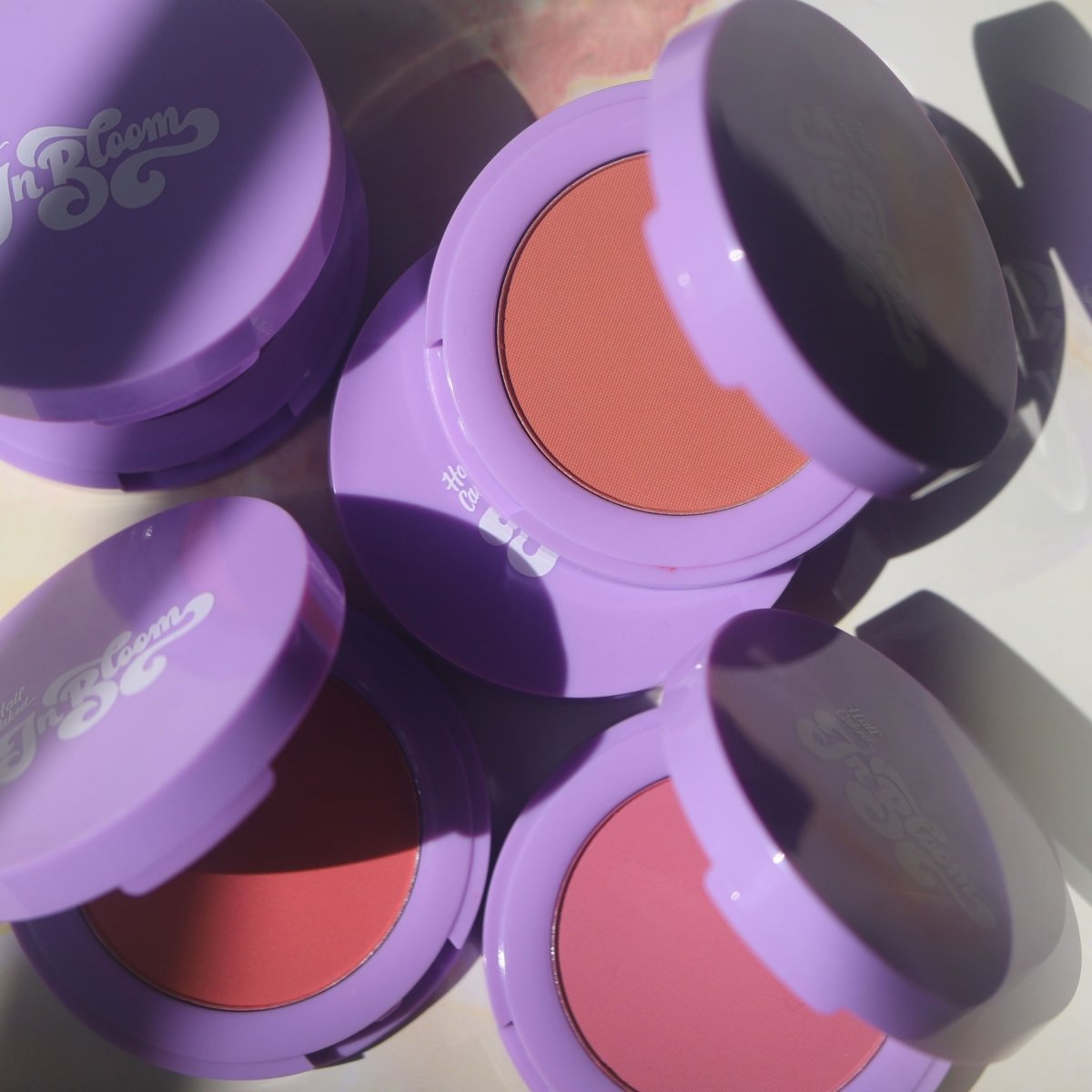 purple compact with pink brown orange pans - In Bloom Powder Blush - Half Caked