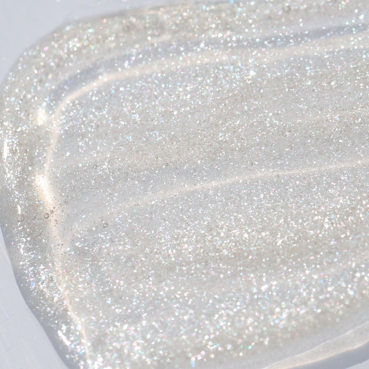 Swatch of clear lip gloss with shimmer - Instant Crush - Sparkle Motion - Half Caked