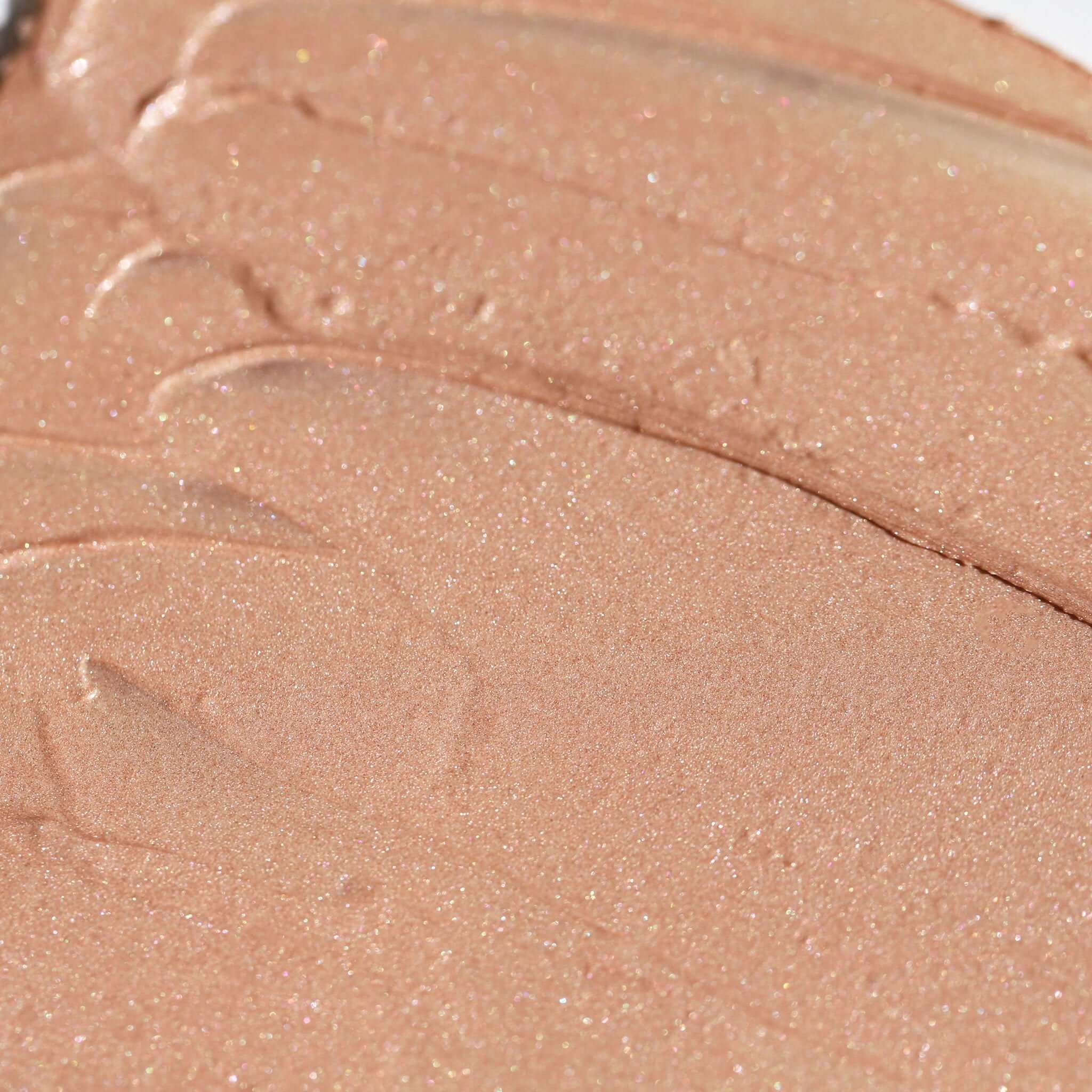 Close-up of a smudge of Candy Paint Cream Highlighter, showcasing its smooth, blendable texture for a dewy, radiant finish.