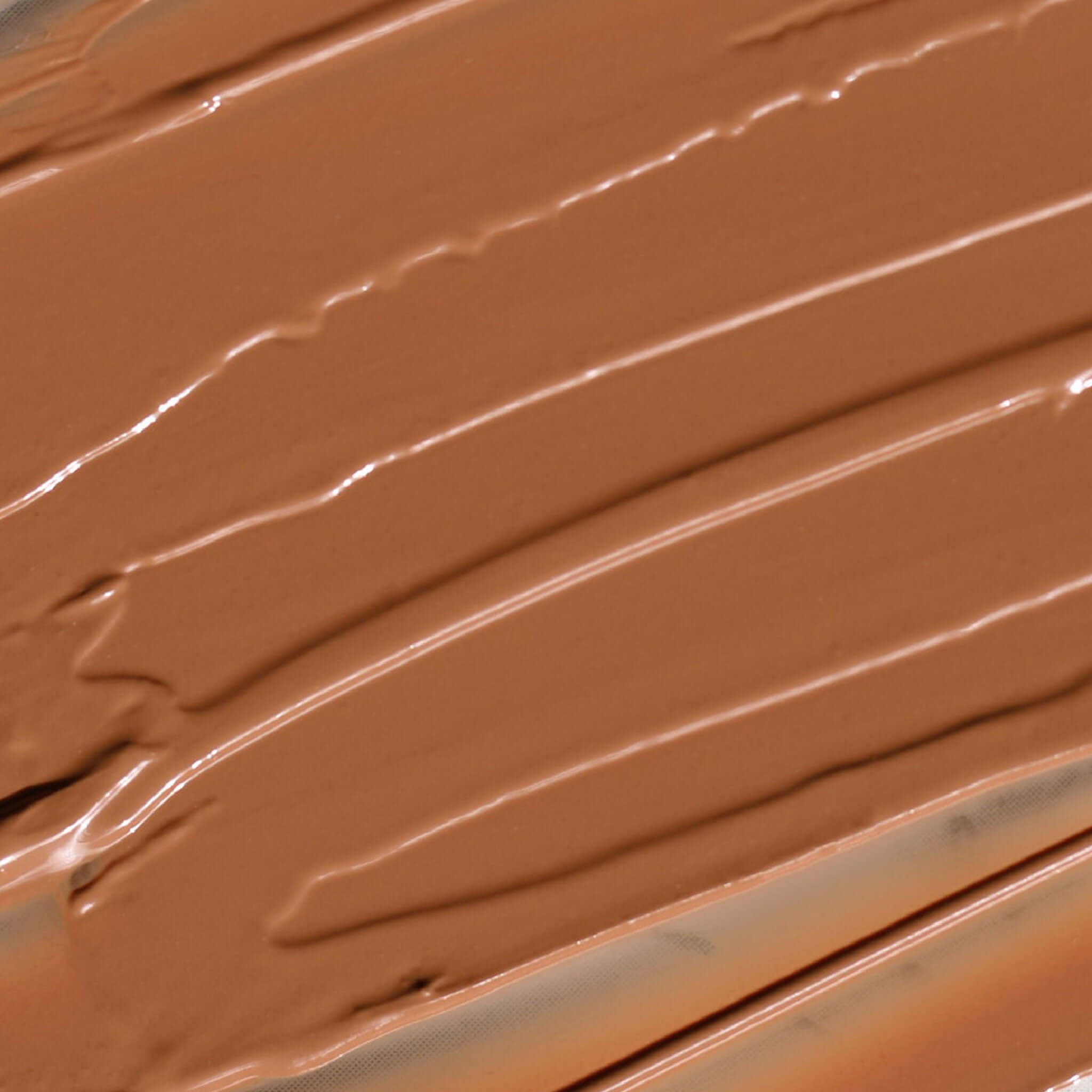 Creamy Candy Paint Cheek + Lip Tint in a warm, dewy finish, shown in a close-up swatch to highlight the product's smooth texture and blendable nature.
