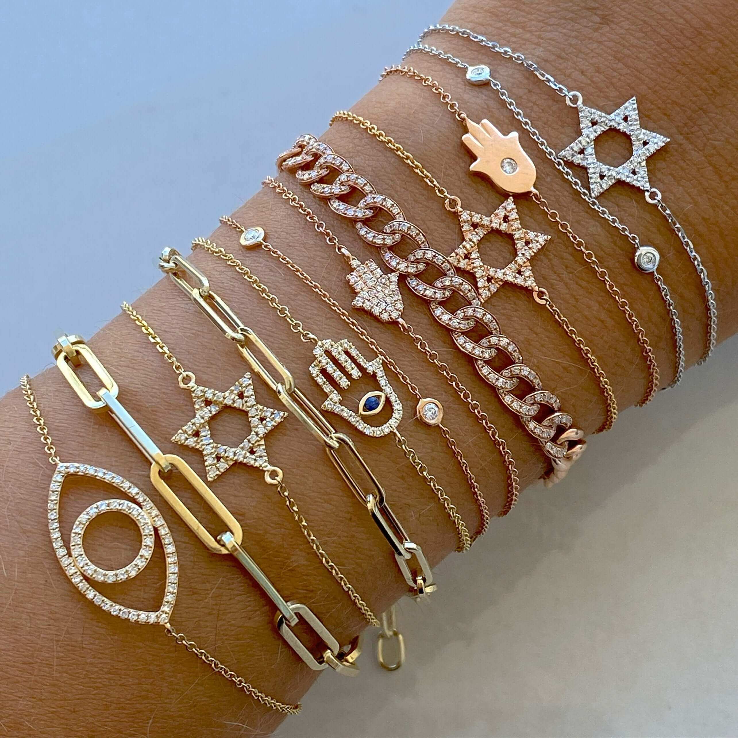 Collection of gold and silver bracelets with star and eye designs from our jewelry brand