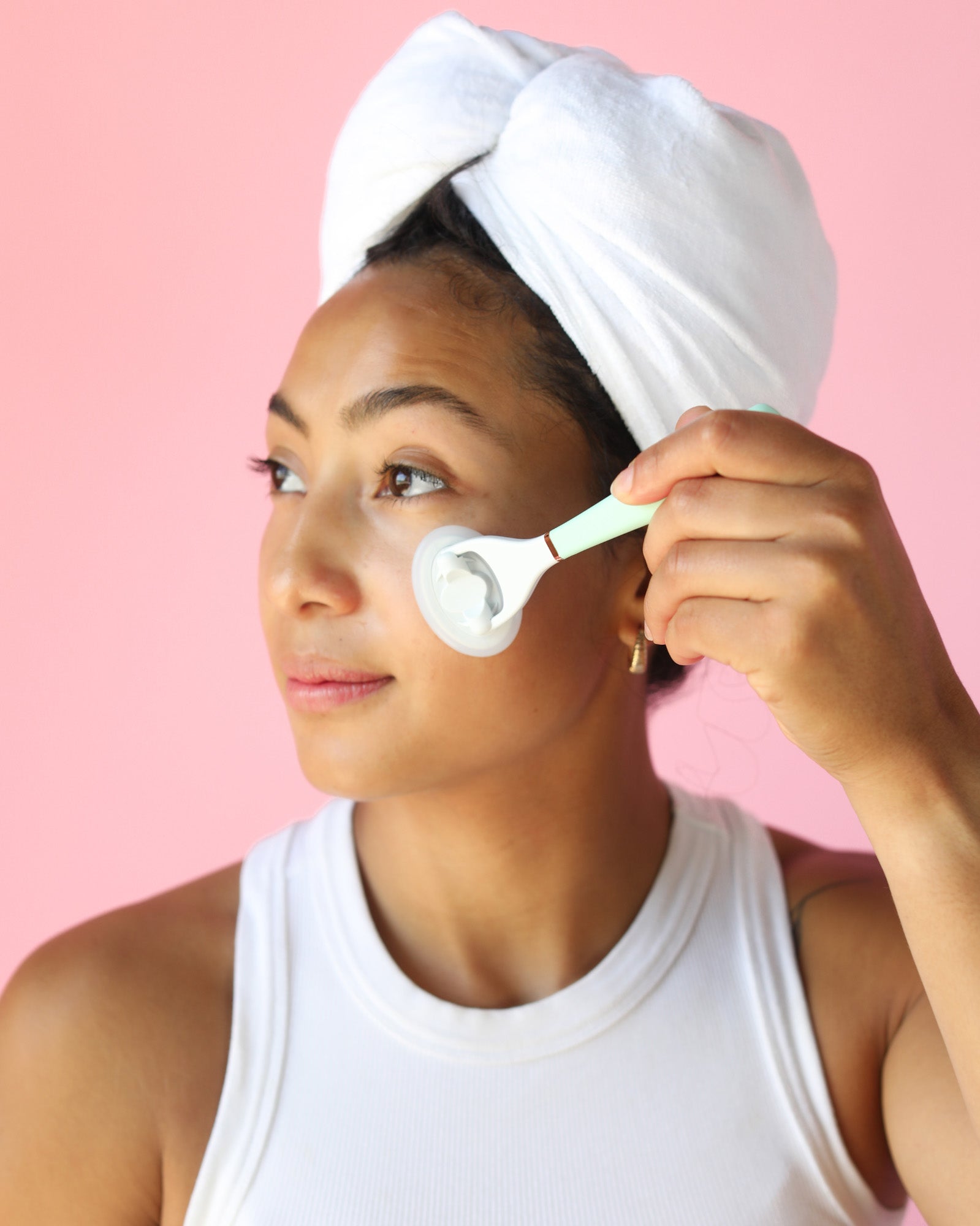 Woman using the Lunaescent skincare applicator