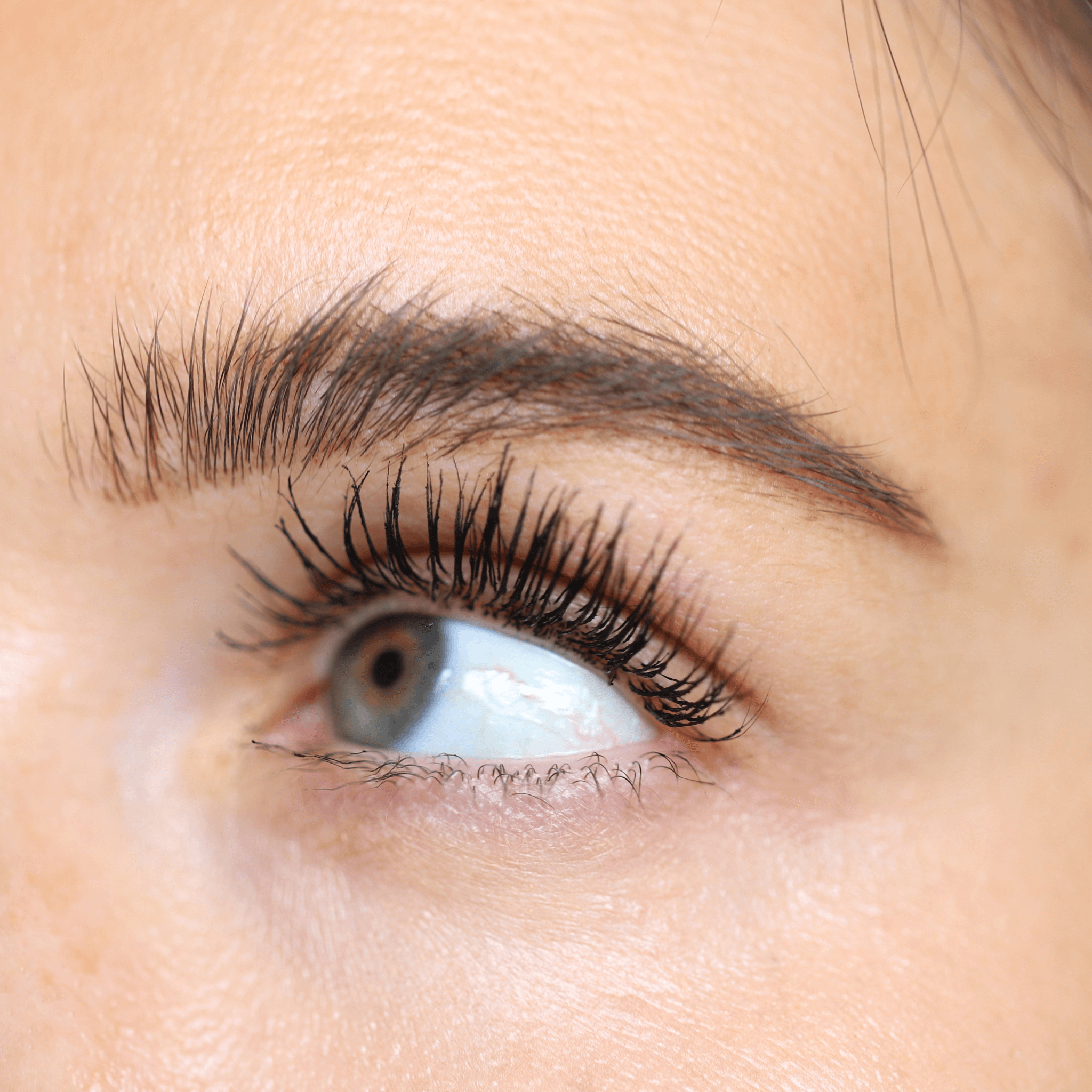 Close-up of an eye with dramatic, volumized lashes wearing Night Show Volumizing Mascara.