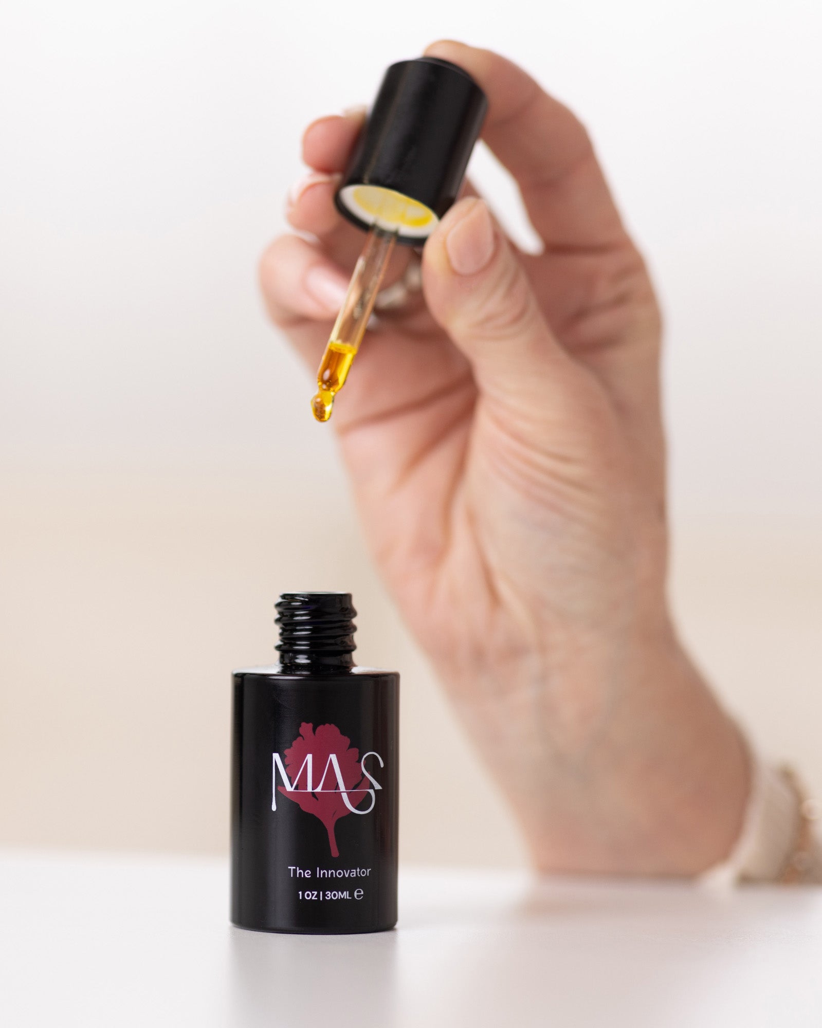 A hand holding The Lunaescent Bundle skin oil dripper