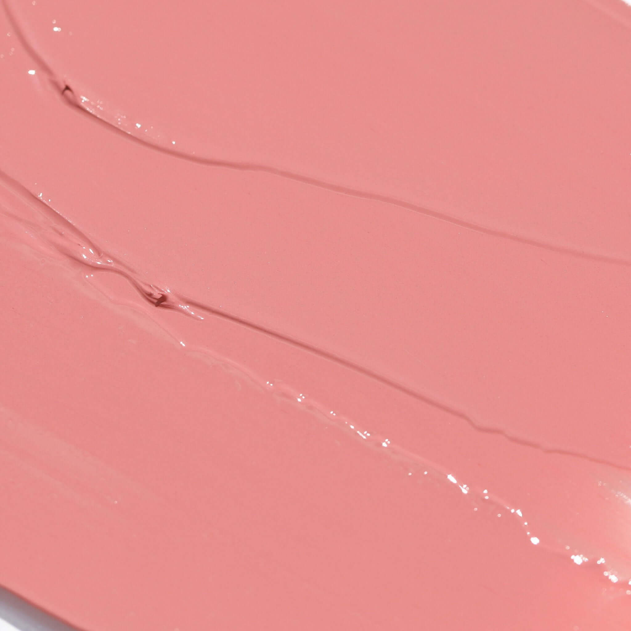 Close-up of Candy Paint Cheek + Lip Tint cream blush in a soft mauve shade with a dewy, blendable texture, perfect for a radiant skin finish.