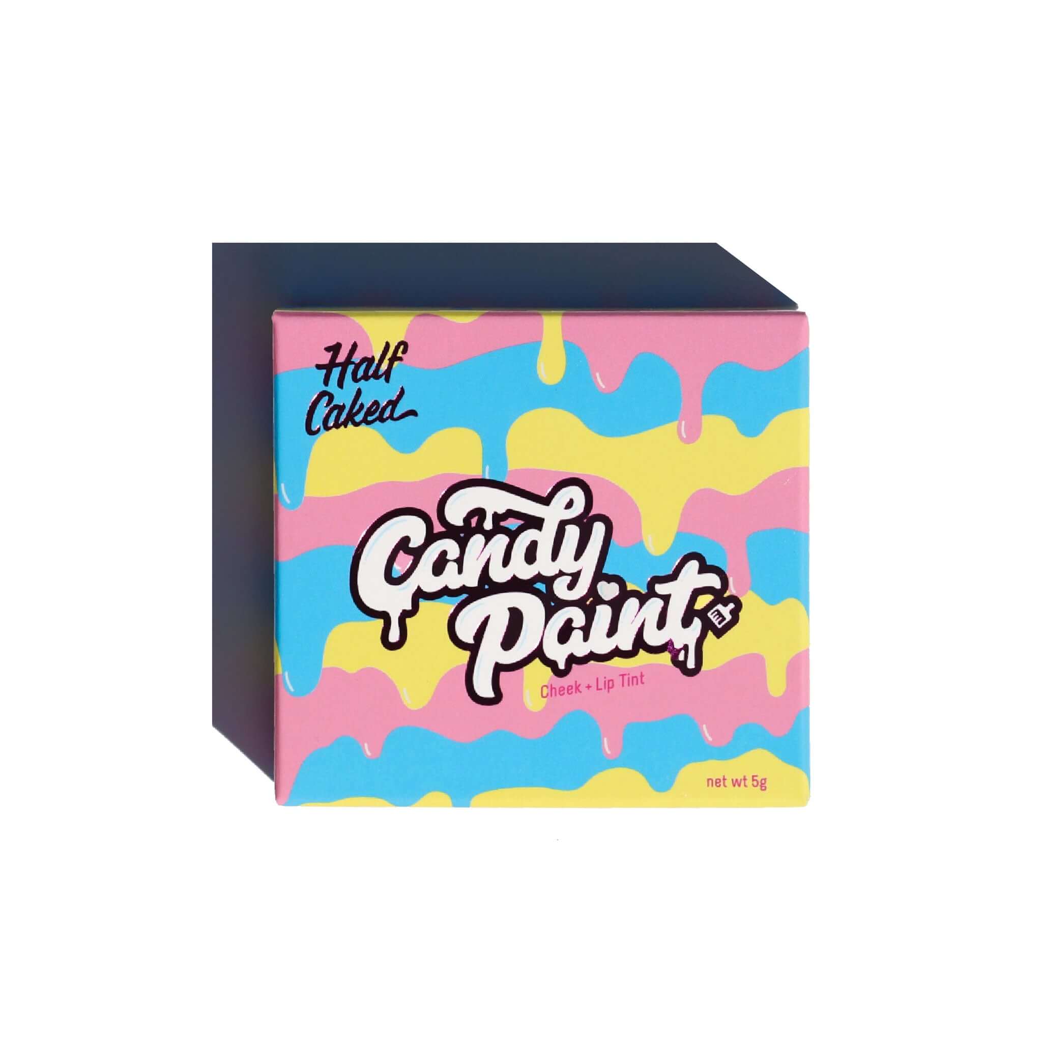 A box of Candy Paint Cream Highlighter with a colorful design, showcasing a heart-shaped compact for dewy, radiant skin.