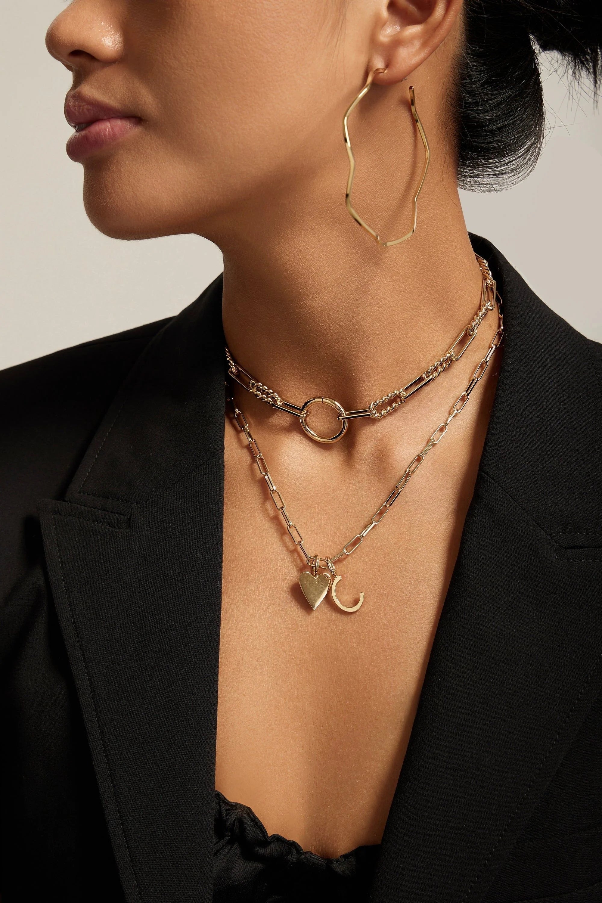 Woman wearing the elegant Eliza Necklace with gold jewelry shine