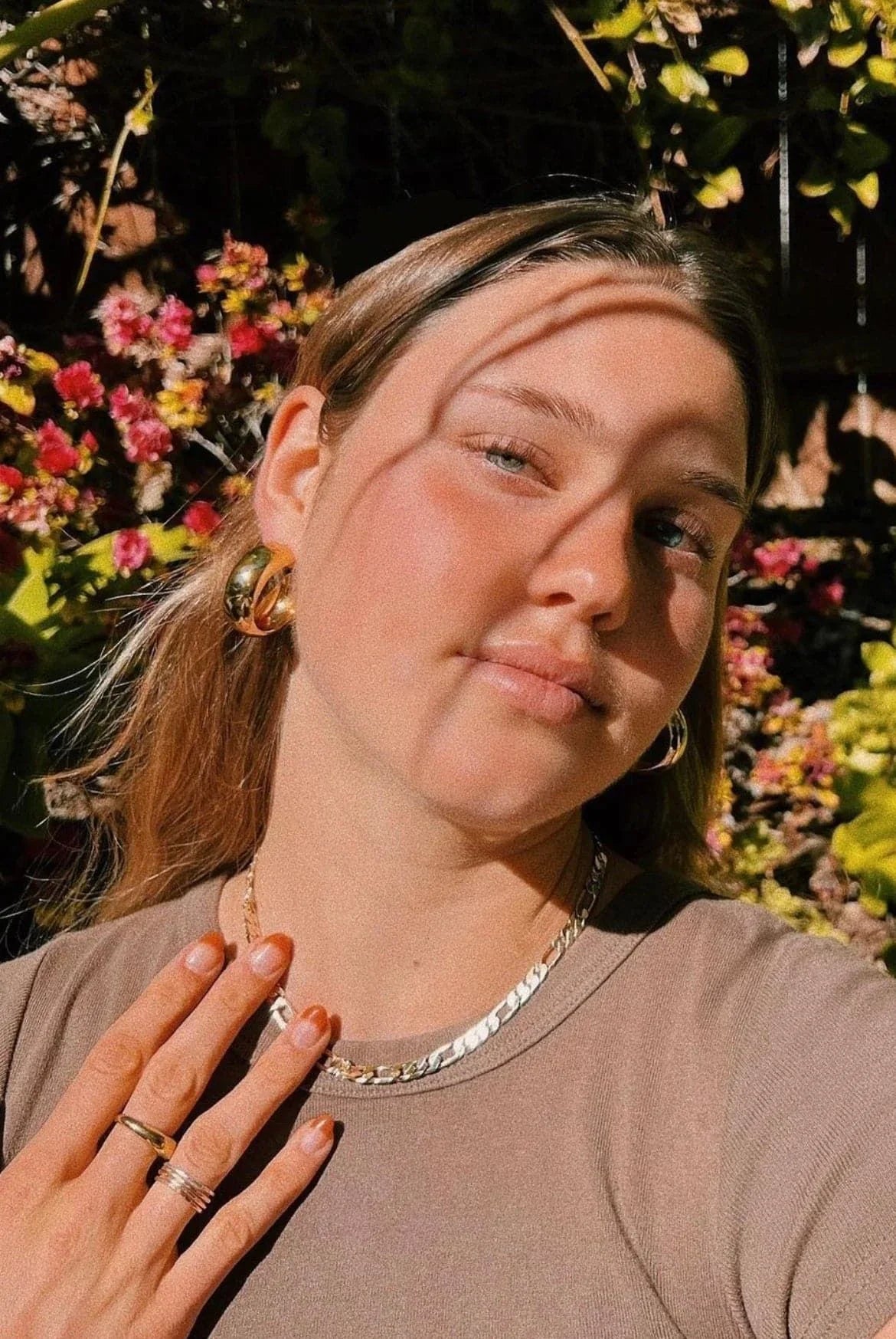Woman wearing beautiful Simone Hoops gold jewelry for a chic look