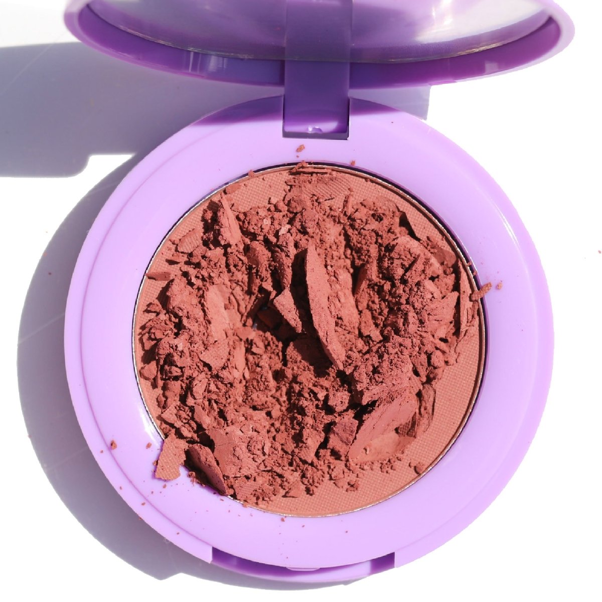 open purple compact with crushed brown pan - In Bloom Powder Blush, day 'n' nite - Half Caked
