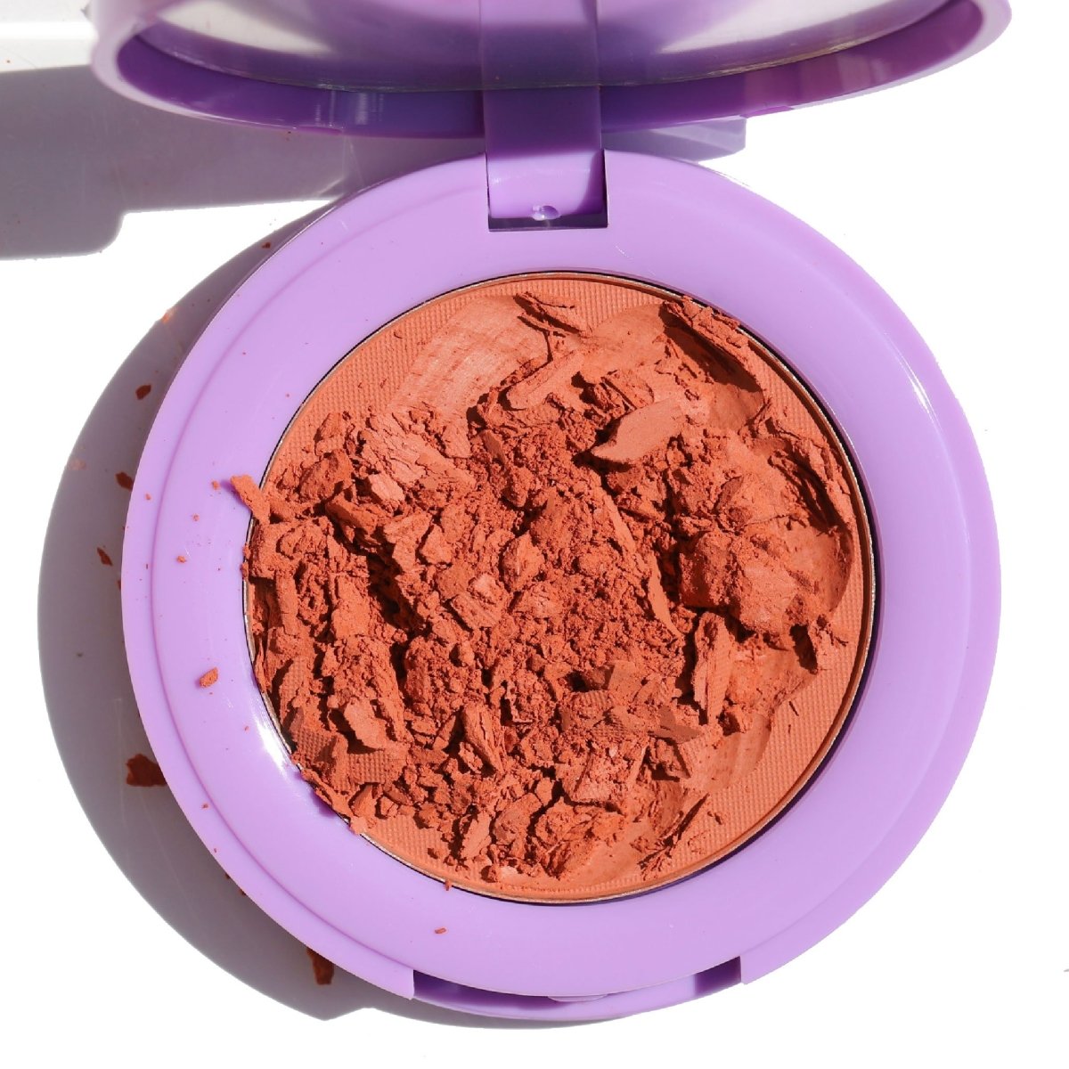 open purple compact with crushed orange blush - In Bloom Powder Blush, liv on sunday - Half Caked