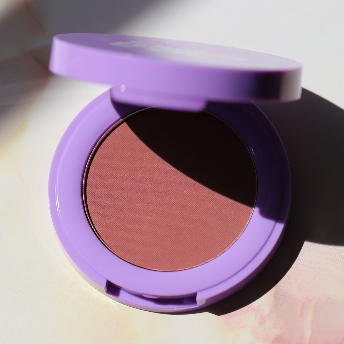 open purple compact with brown pan - In Bloom Powder Blush, day 'n' nite - Half Caked