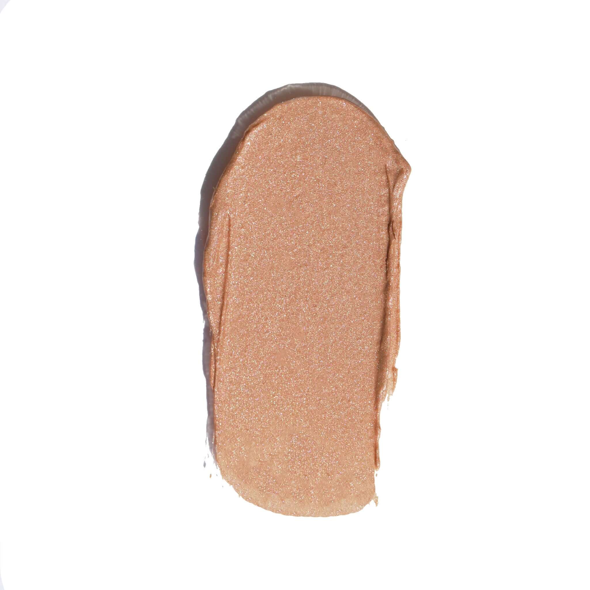 A close-up of Candy Paint Cream Highlighter's smooth, tan smear, showcasing its blendable texture for a dewy, radiant finish.